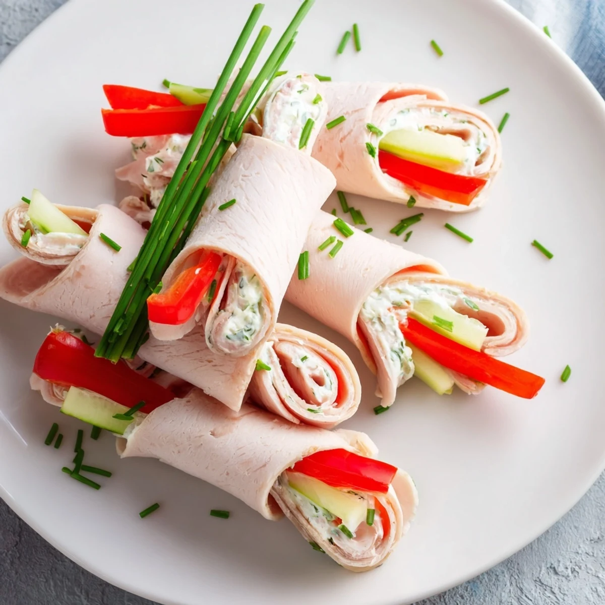 Stacked turkey roll-ups, light and refreshing, served on a platter ready for a party.