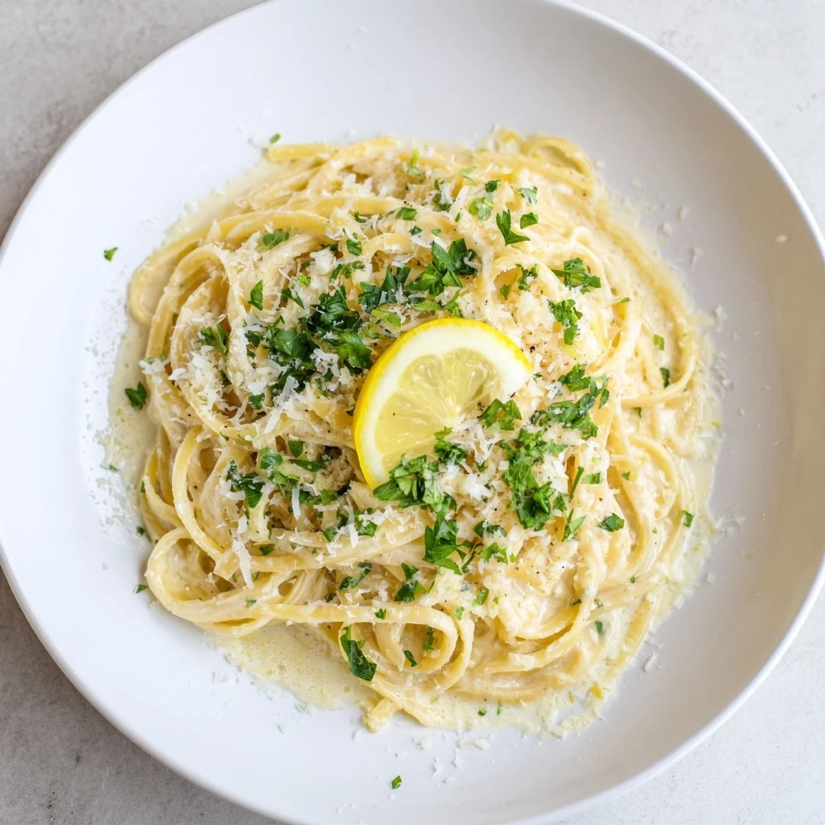 Enjoy a quick, delicious serving of Lemon-Garlic Greek Yogurt Pasta, perfect for a light vegetarian meal.