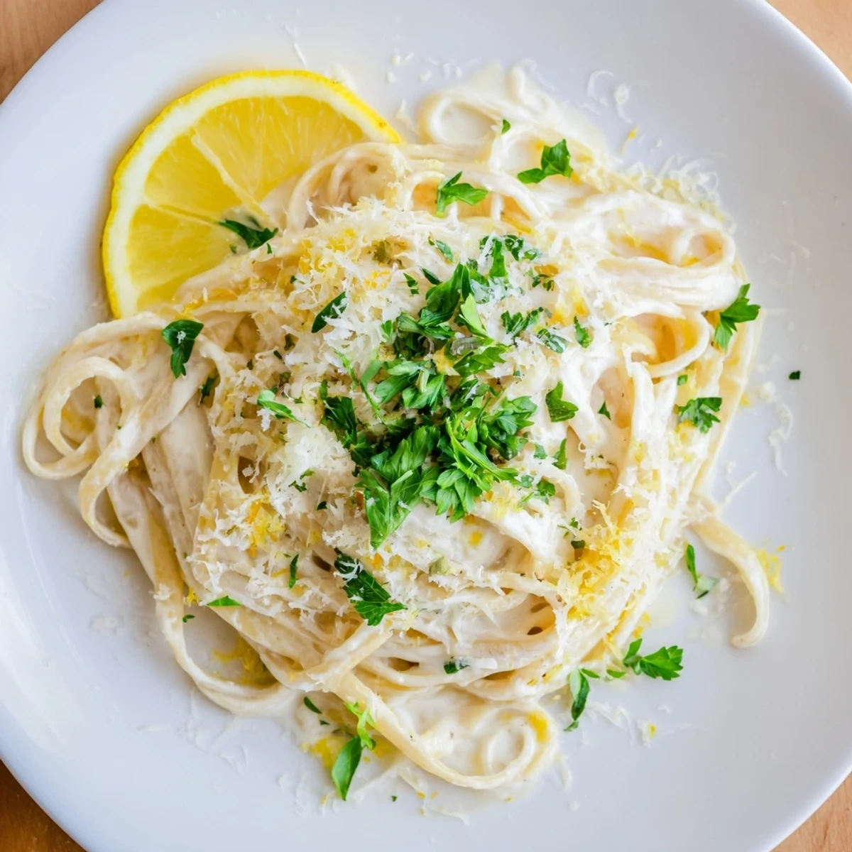 A bowl of bright Lemon-Garlic Greek Yogurt Pasta with grated Parmesan cheese is very appetizing.
