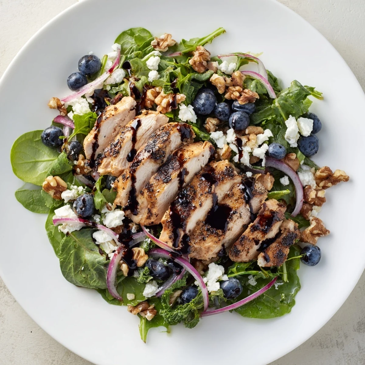 Vibrant Blueberry Goat Cheese Chicken Salad with glistening balsamic glaze and fresh blueberries.