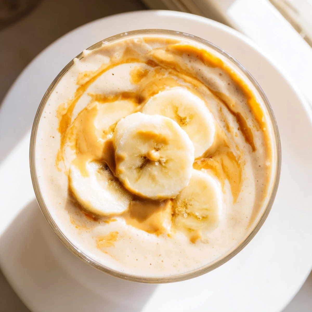 A thick, blended Peanut Butter Banana Smoothie, perfect for grabbing with a spoon this morning.
