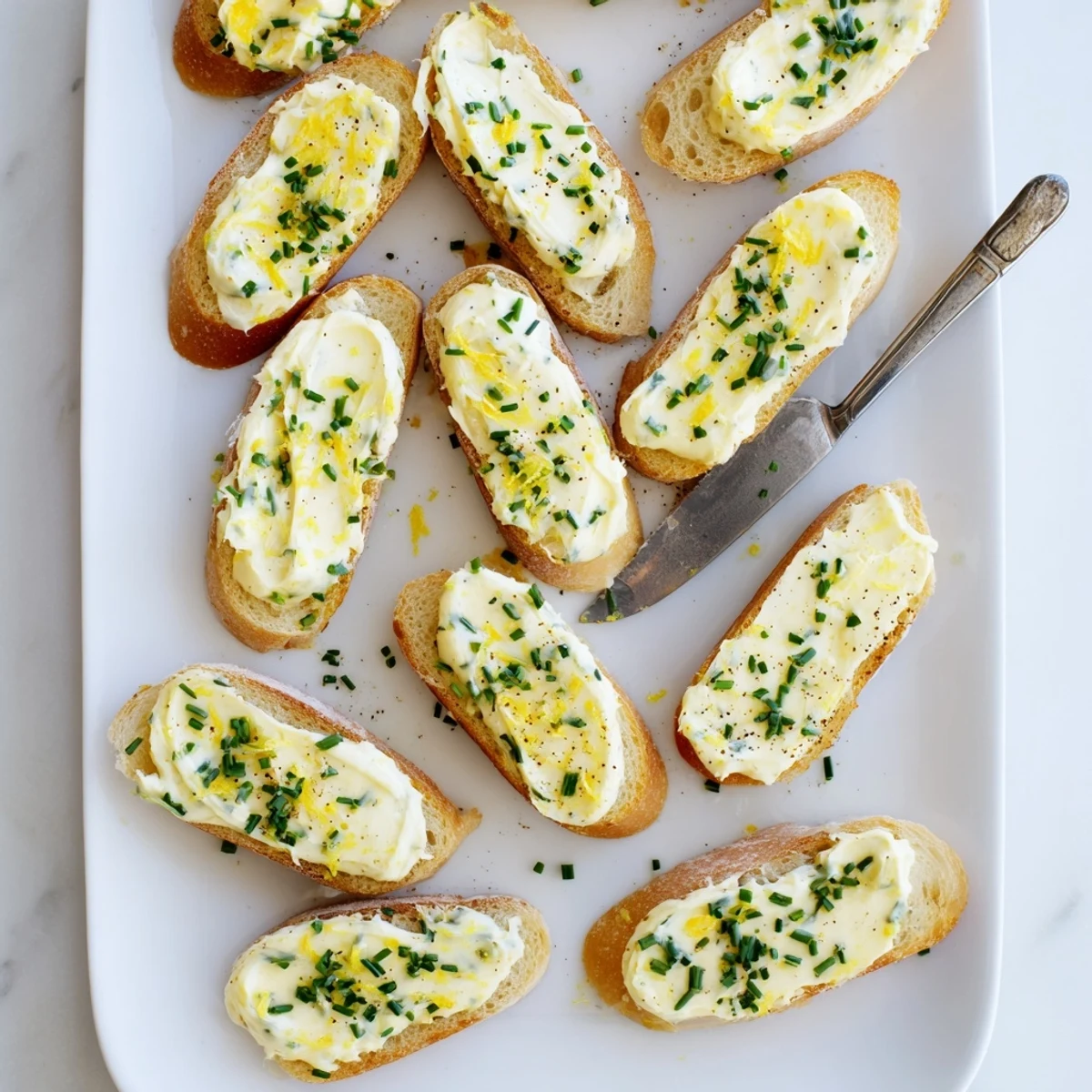 Crisp, toasted Vodka Butter Crostini slices topped with smooth butter, fresh herbs, and a hint of lemon, perfect for elegant appetizers.