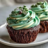 Green velvet cupcakes with vibrant green frosting, perfect for a festive St. Patrick's Day dessert table.