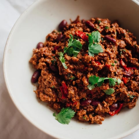 Rich, simmering Smoky Mole Chili, boasting a deep, dark hue, ready to be served.