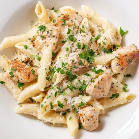 Golden chicken pieces mingle with pasta in this creamy Quick Garlic Parmesan Chicken Pasta dish.