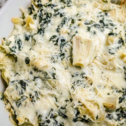 Warm and bubbly spinach artichoke dip, served with crispy tortilla chips, ready to enjoy.