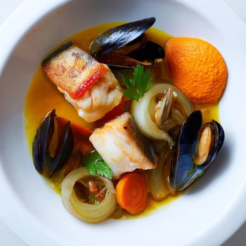 Steaming hot bouillabaisse, a flavorful Provençal fish stew, loaded with fresh seafood and vegetables.