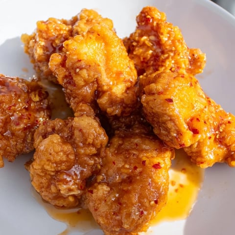 Glistening Hot Honey Butter Chicken, perfectly fried and drizzled, ready to be devoured.