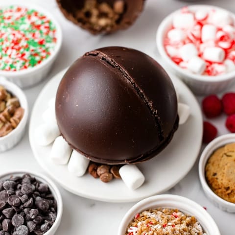 Festive setup of creamy hot cocoa bombs ready to be paired with various delectable toppings.