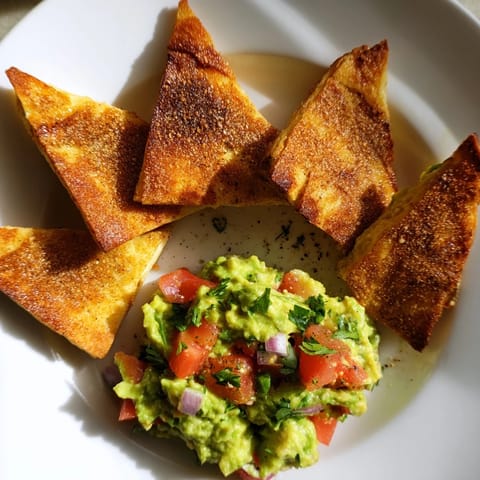 This flavorful Pita Chips and Guacamole Bowl shows golden, toasted pita triangles ready for dipping into fresh guacamole.