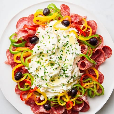 A close-up view of the delicious Medusa Curls appetizer with salami, prosciutto, and red peppers coiled.