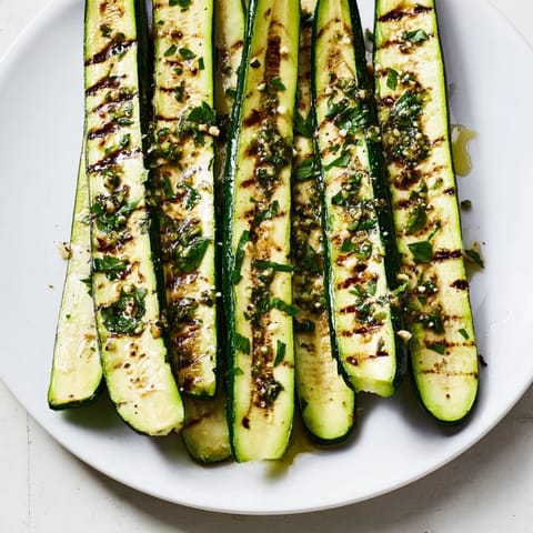 Fresh herbs and garlic infusing this Garlic Herb Grilled Zucchini, a flavorful Mediterranean side.