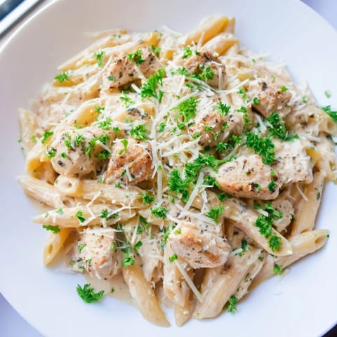 A flavorful skillet of Quick Garlic Parmesan Chicken Pasta with herbs, perfect for dinner tonight.