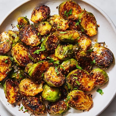 Warm, flavorful dish of Honey Mustard Glazed Brussels Sprouts, showcasing roasted halves, ready for serving right now.