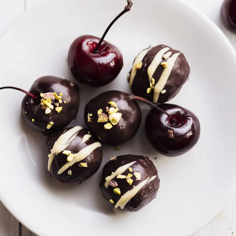 Artificially vibrant maraschino cherries peek from beneath layers of chocolate cherry dessert bites.