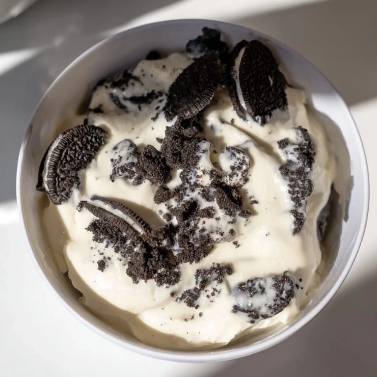 Vanilla pudding with crushed Oreos, garnished and served in glass dishes, ready for enjoyment.