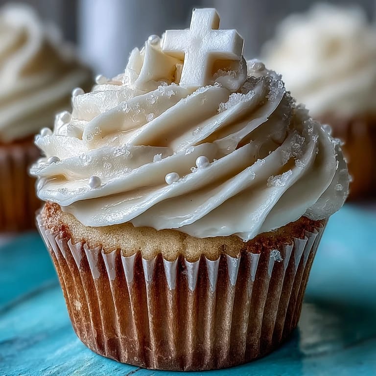 Delightful vanilla cupcakes topped with smooth buttercream and delicate fondant crosses, ideal for religious gatherings or special occasions.  